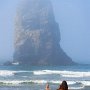 Oregon coast. Woman and the sea stack